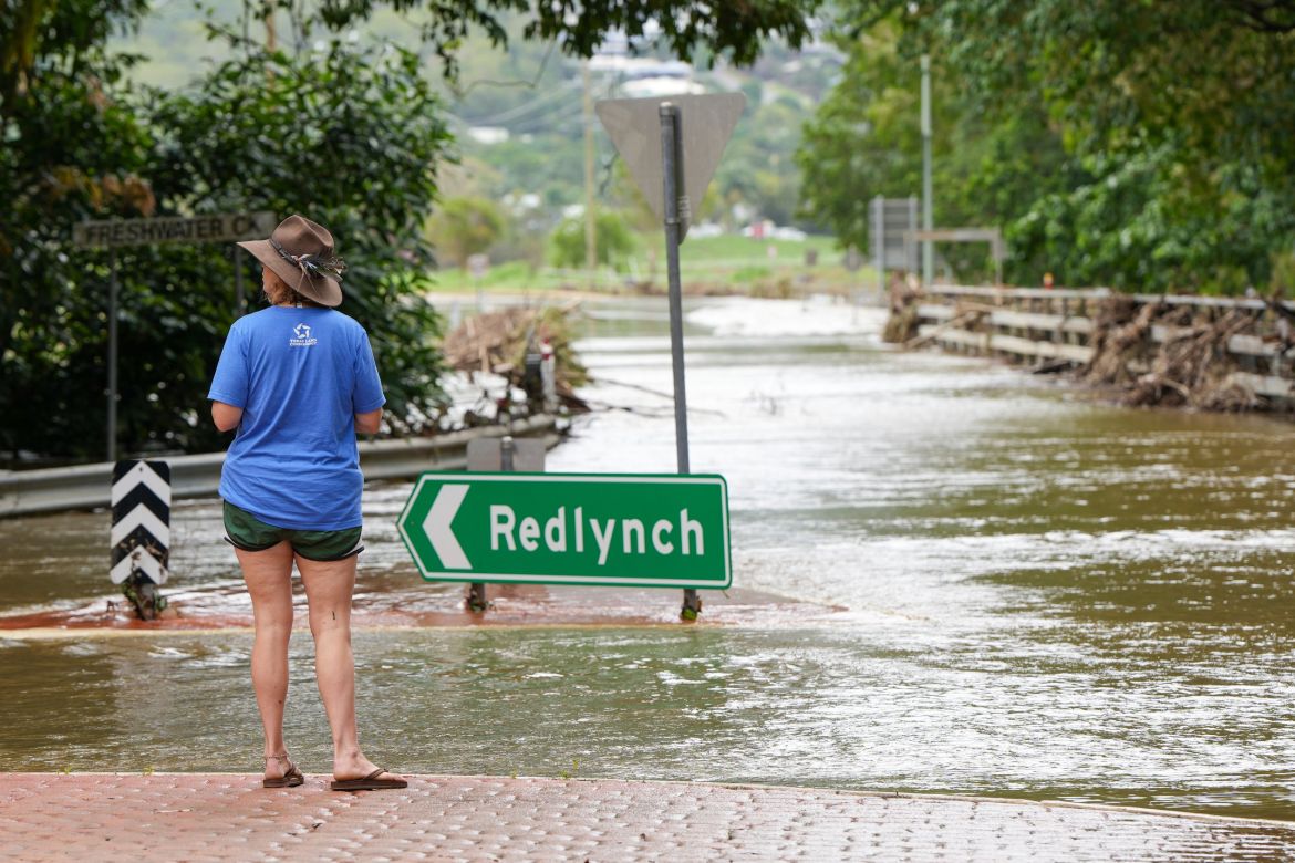 A resident inspects floodwater at Stratford in Cairns, Queensland, Australia, 18 December