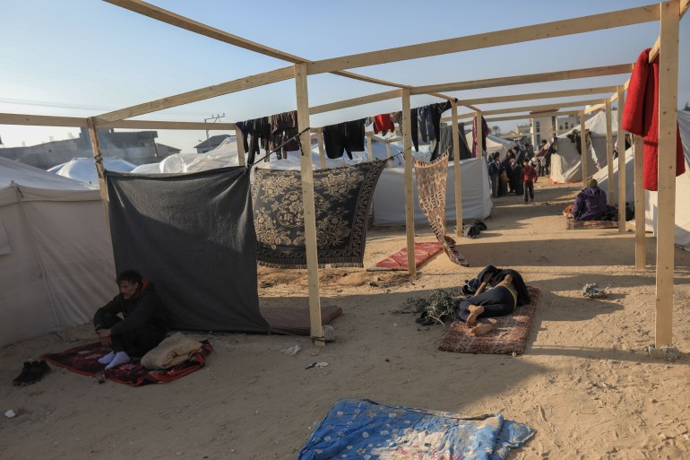 the dirt spaces between makeshift tents