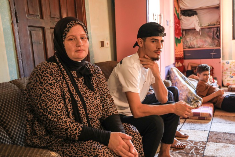 Ola al-Saeedi and her son Khader in a relative's house in the central town of Deir al-Balah 