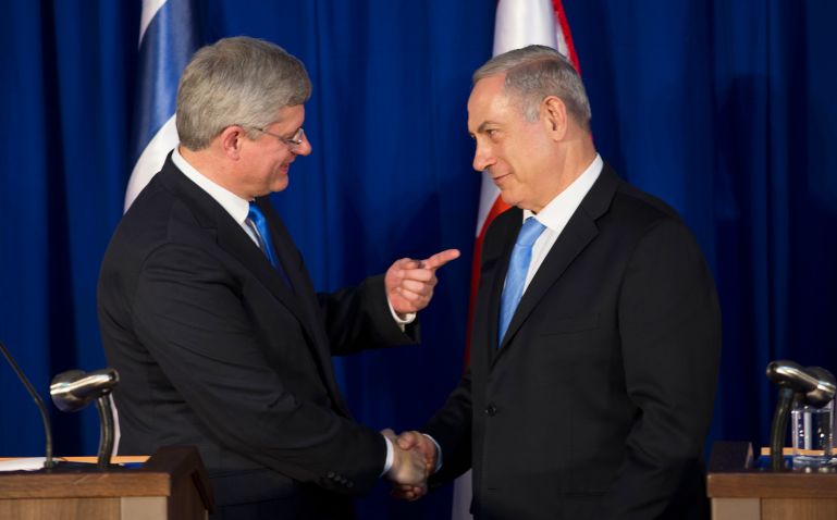 Former Canadian Prime Minister Stephen Harper shakes hands with Israeli Prime Minister Benjamin Netanyahu in 2014