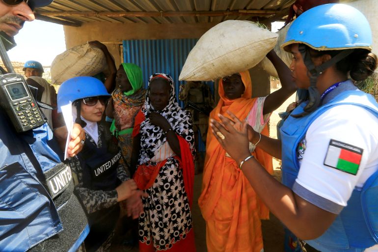 United Nations staff talk to internally displaced Sudanese women in Darfur