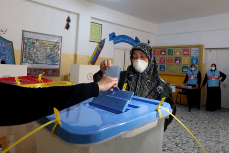 A woman votes at municipal elections in Libya 2021