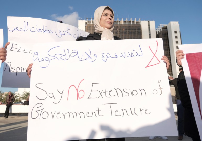A woman protests postponement of elections in Libya