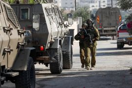 Israeli soldiers repeatedly raid Palestinian towns and cities in the occupied West Bank. The International Court of Justice is hearing a case brought forward by the UN General Assembly into the legality of the occupation [Mohamad Torokman/Reuters]