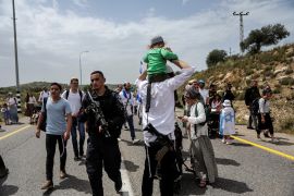 Israeli settlers hold a protest march