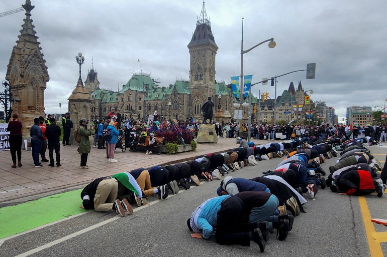 People pray in front of Parliament Hill in Ottawa in support of Palestinians in Gaza