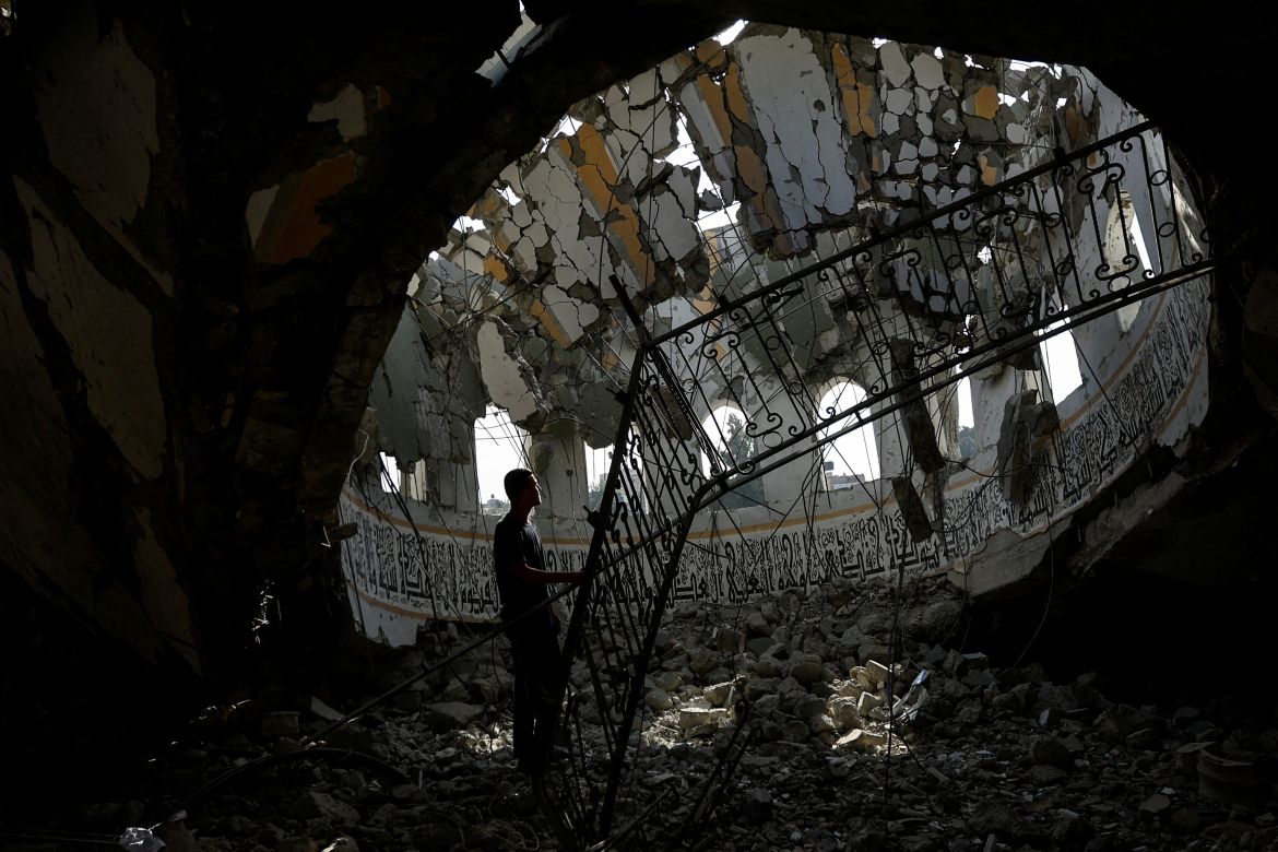 A Palestinian man inspects the site of an Israeli strike on a mosque, amid the ongoing conflict between Israel and Palestinian Islamist group Hamas, in Khan Younis in the southern Gaza Strip.