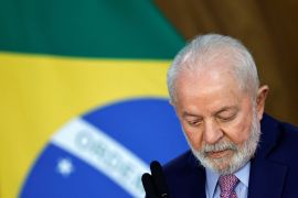 A close up of Brazilian President Lula da Silva against the Brazilian flag.