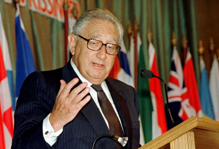 Visiting former U.S. Secretary of State Henry Kissinger addresses an American Chamber of Commerce business luncheon in Bangkok, Thailand January 22, 1998