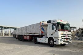 A truck transports humanitarian aid after entering Gaza through the Rafah border crossing between Egypt and the Gaza Strip, on Saturday [Palestine Red Crescent Society/Handout via Reuters]