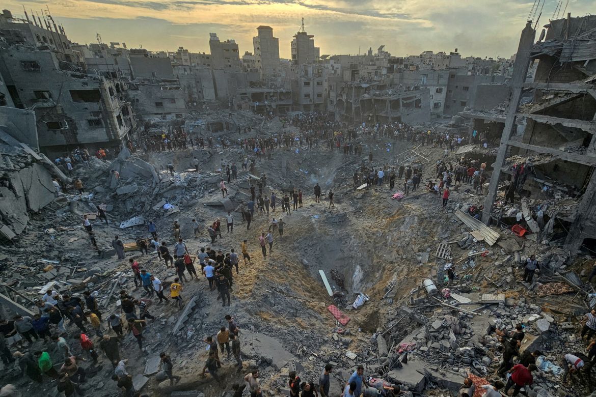 Palestinians search for casualties at the site of Israeli strikes on houses in Jabalia refugee camp in the northern Gaza Strip.
