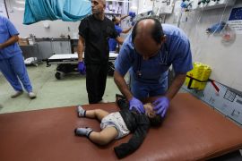 A medical worker assists a wounded Palestinian baby at the Nasser Medical Complex following Israeli attacks in Khan Younis in the southern Gaza Strip [Ibraheem Abu Mustafa/Reuters]