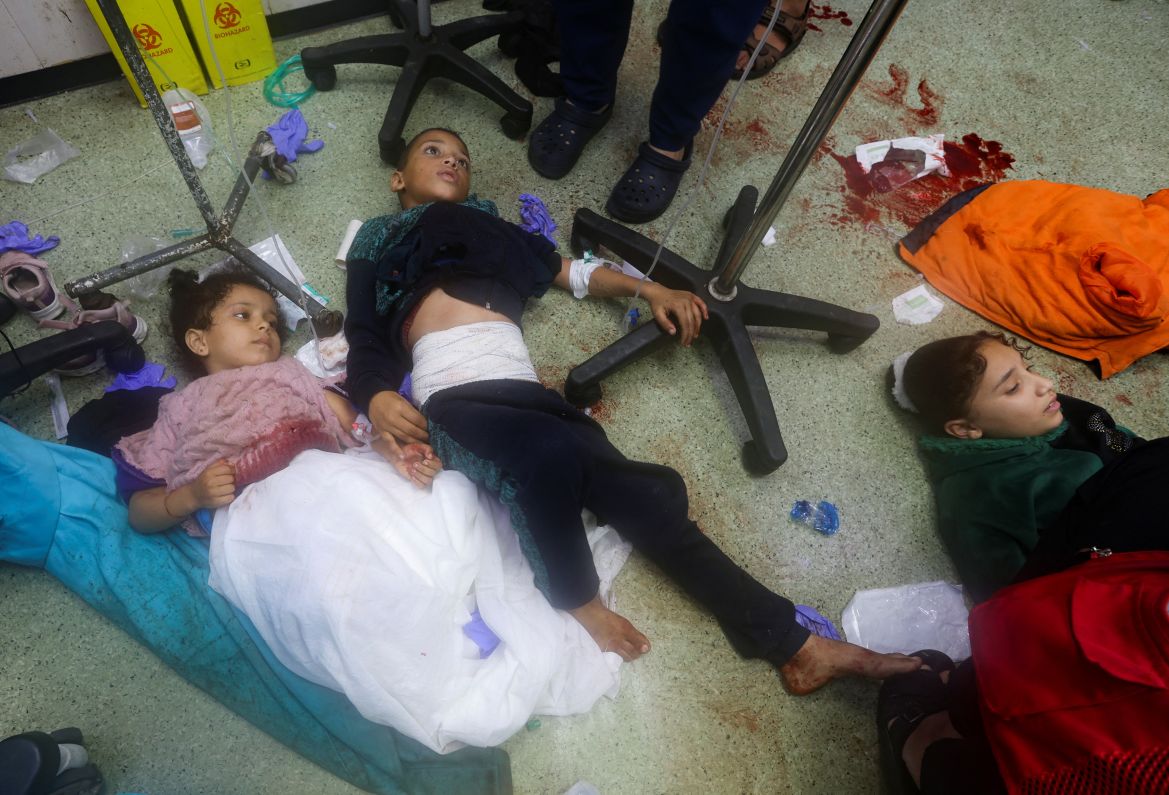 Wounded Palestinian children lie on the floor at Nasser hospital