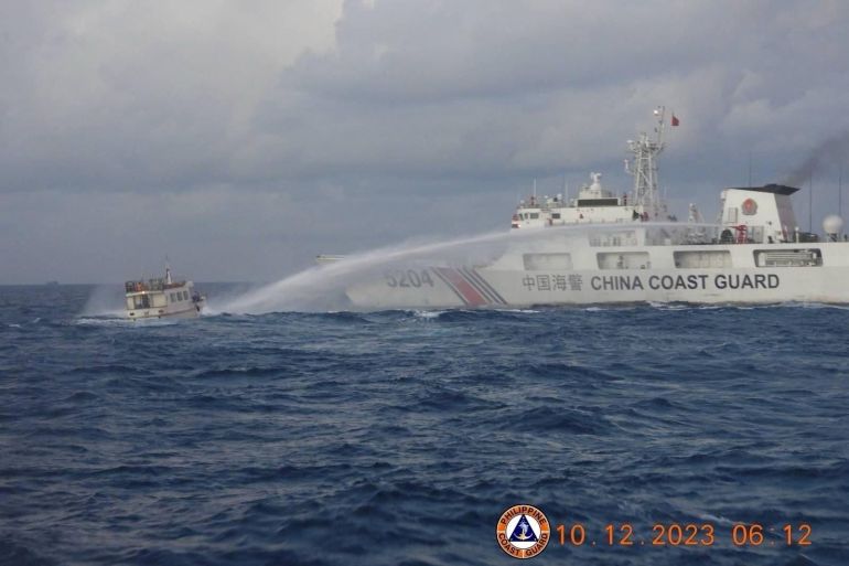 A Chinese Coast Guard ship firing water cannon at a Philippines vessel