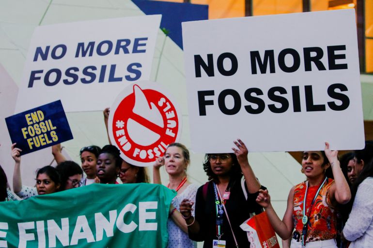 Climate activists protest against fossil fuels at Dubai's Expo City during the United Nations Climate Change Conference COP28