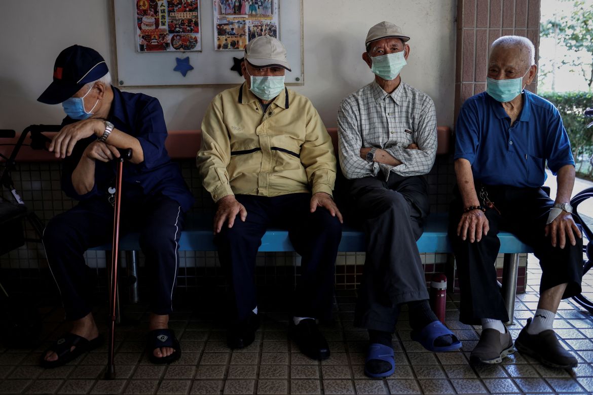 Sun Kuo-hsi, 110, sits with other residents in the hallway of Taoyuan Veterans Home in Taoyuan, Taiwan.