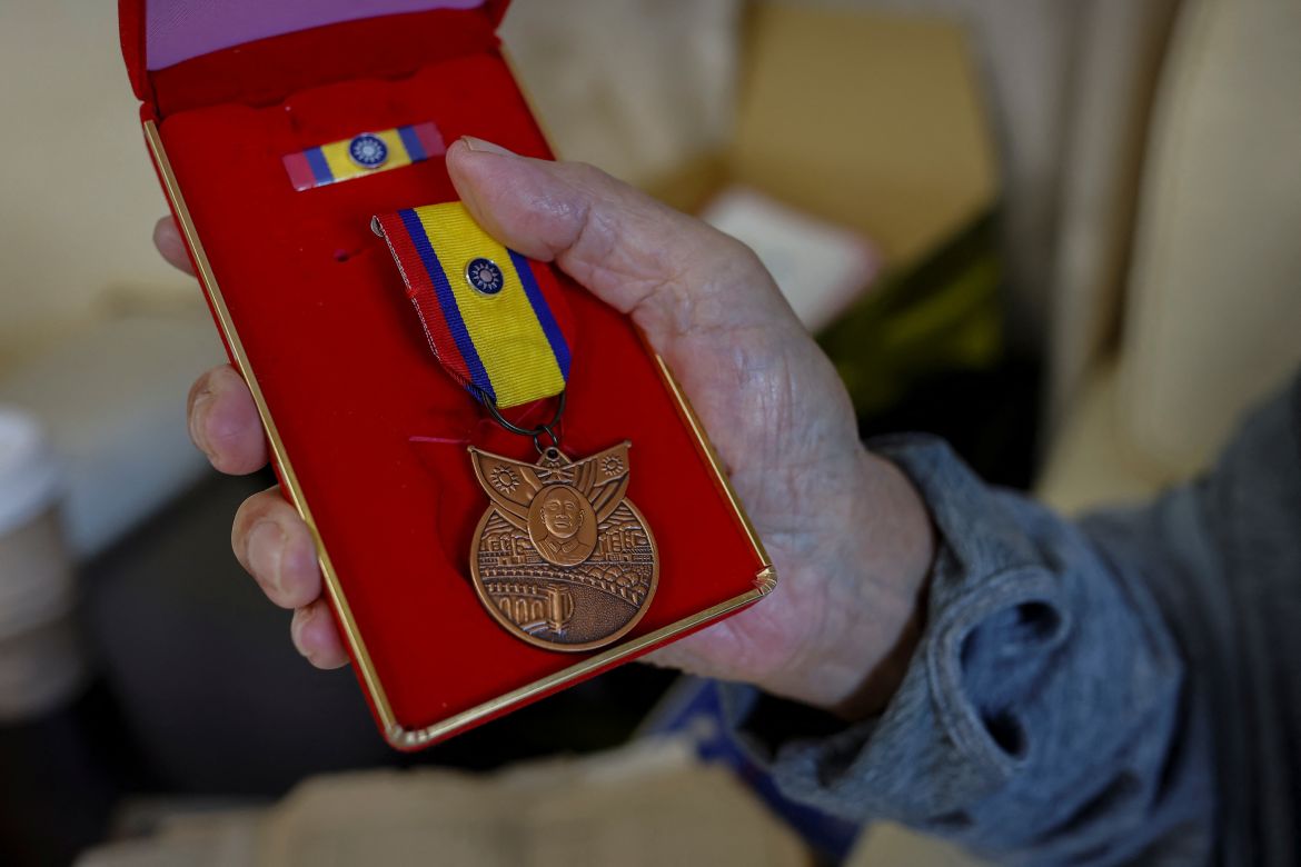 Sun Kuo-hsi, 110, a resident of Taoyuan Veterans Home, shows to the camera a medal he was awarded after taking part in the Marco Polo Bridge incident in 1937.
