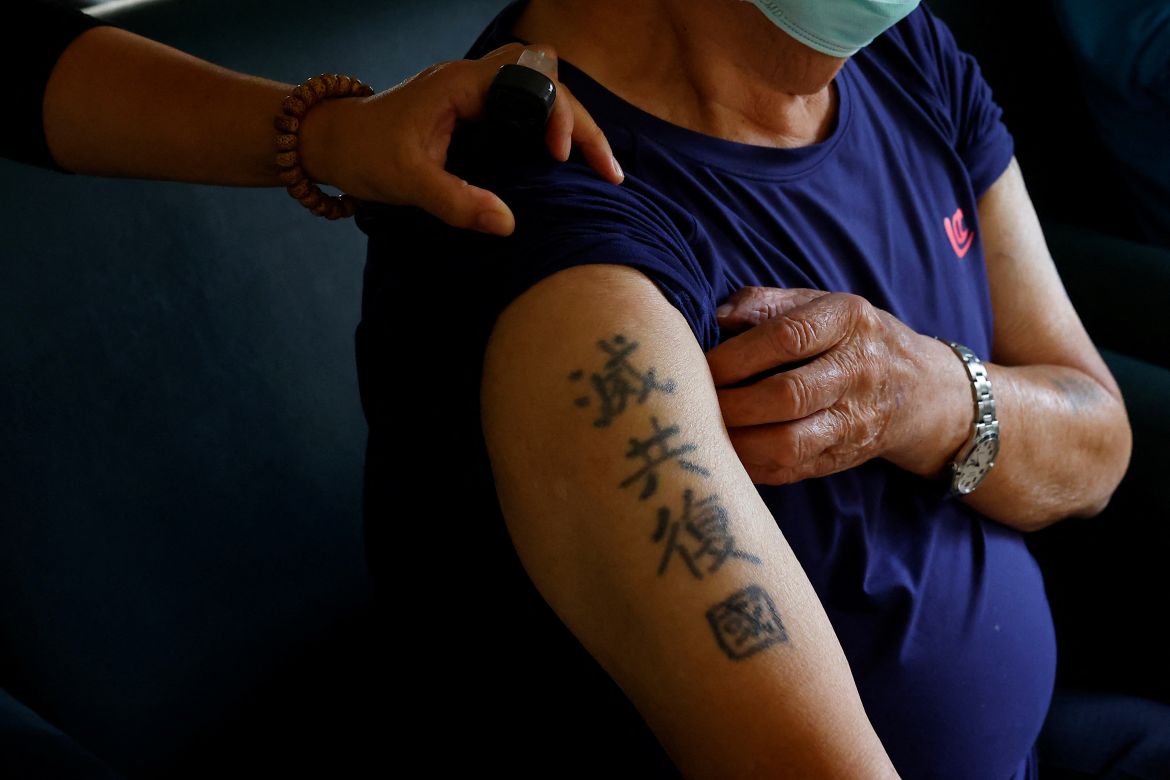 Luo Yao-fu, a resident of Taoyuan Veterans Home, shows a tattoo on his arm which reads "Annihilate the communists, recover the nation" during an interview with Reuters in Taoyuan, Taiwan.