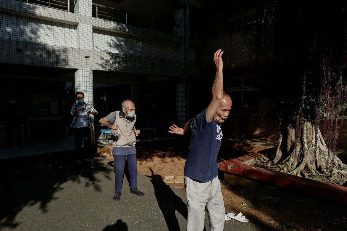 Residents of Taoyuan Veterans Home gather in the courtyard for a morning workout in Taoyuan, Taiwan.