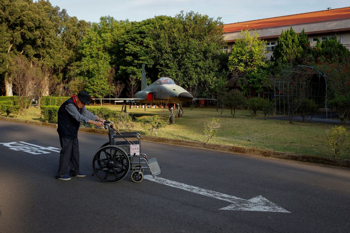A man walks by a retired F-5 fighter jet inside Taoyuan Veterans Home in Taoyuan, Taiwan.