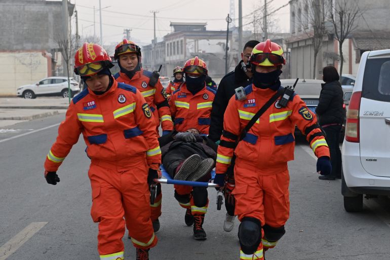 Rescue workers carry an injured person