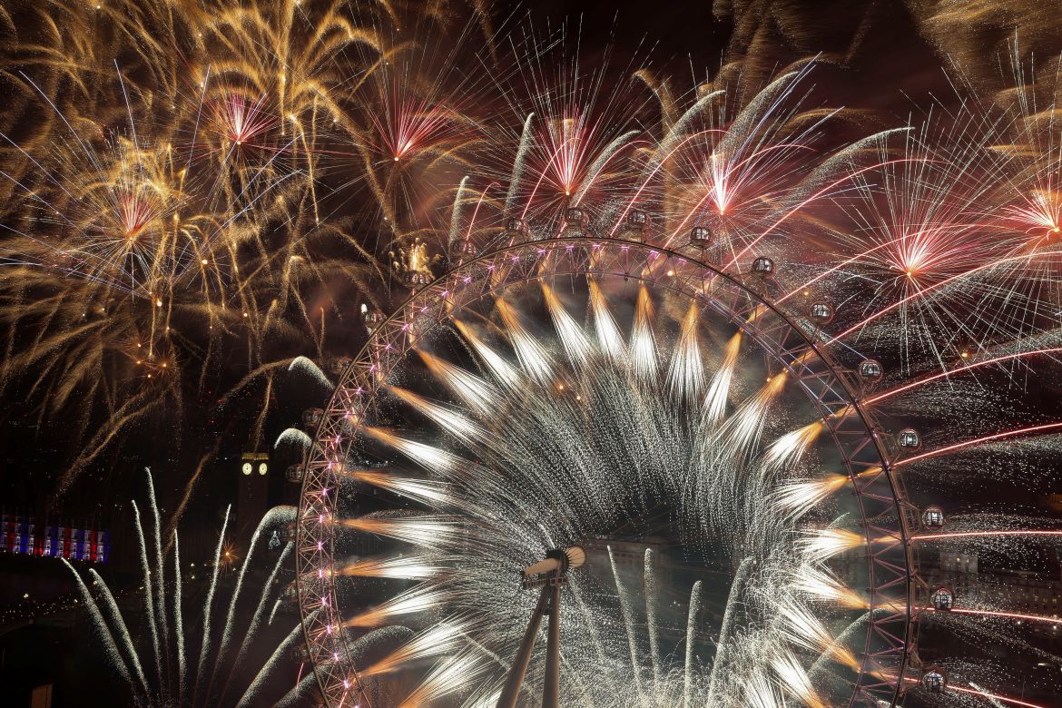 Fireworks on the London Eye and in the sky behind