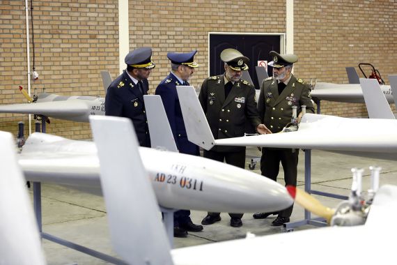This handout picture released by Iran's Army office on April 19, 2023 shows military chief Major General Abdolrahim Mousavi (R) and Defence Minister Mohammad Reza Ashtiani (2nd-R) taking part in the unveiling ceremony of 200 unmanned aerial vehicles (UAV or drone) at an undisclosed location in Iran. (Photo by Iranian Army office / AFP) / === RESTRICTED TO EDITORIAL USE - MANDATORY CREDIT "AFP PHOTO / HO / IRANIAN ARMY OFFICE" - NO MARKETING NO ADVERTISING CAMPAIGNS - DISTRIBUTED AS A SERVICE TO CLIENTS ===