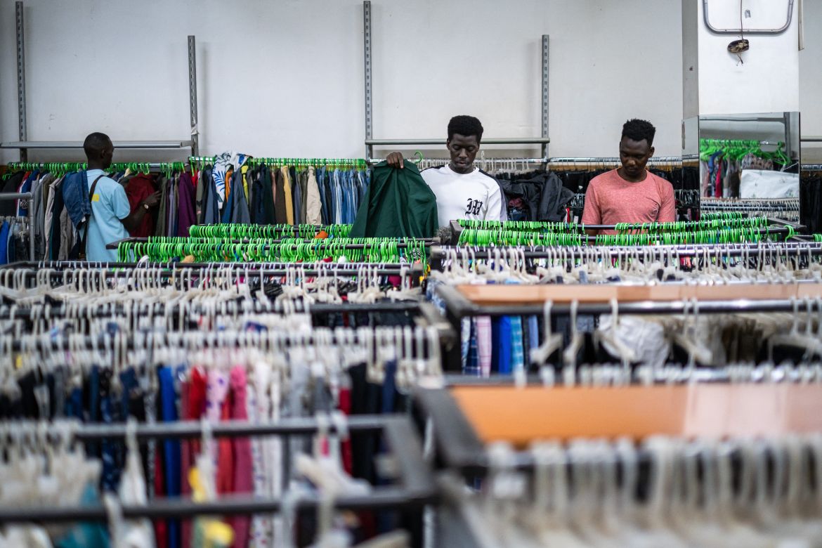 Buyers pick clothes from Green Shop, a modern second-hand shop in Kampala.