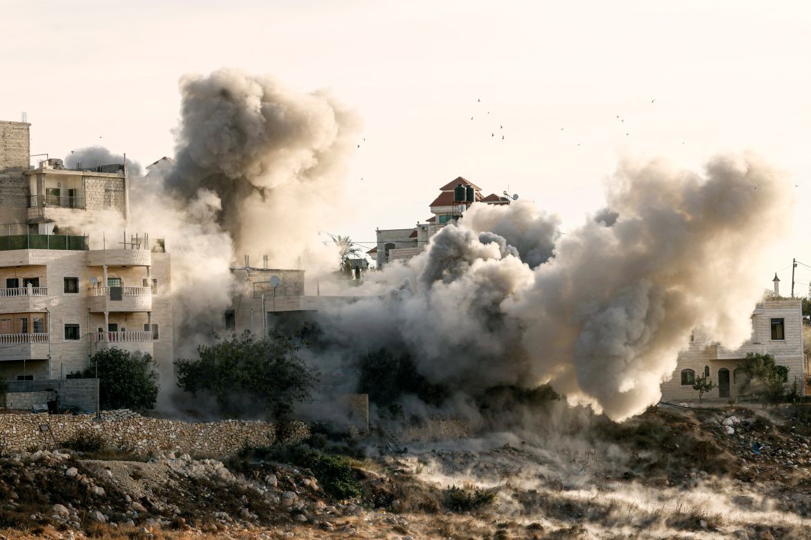 Smokes billows as one of two Palestinian homes are blown up which according to Israeli security forces belonged to arrested members of Hamas and who are said to be responsible for a shooting attack last August 21, in West Bank city of Hebron on November 10.