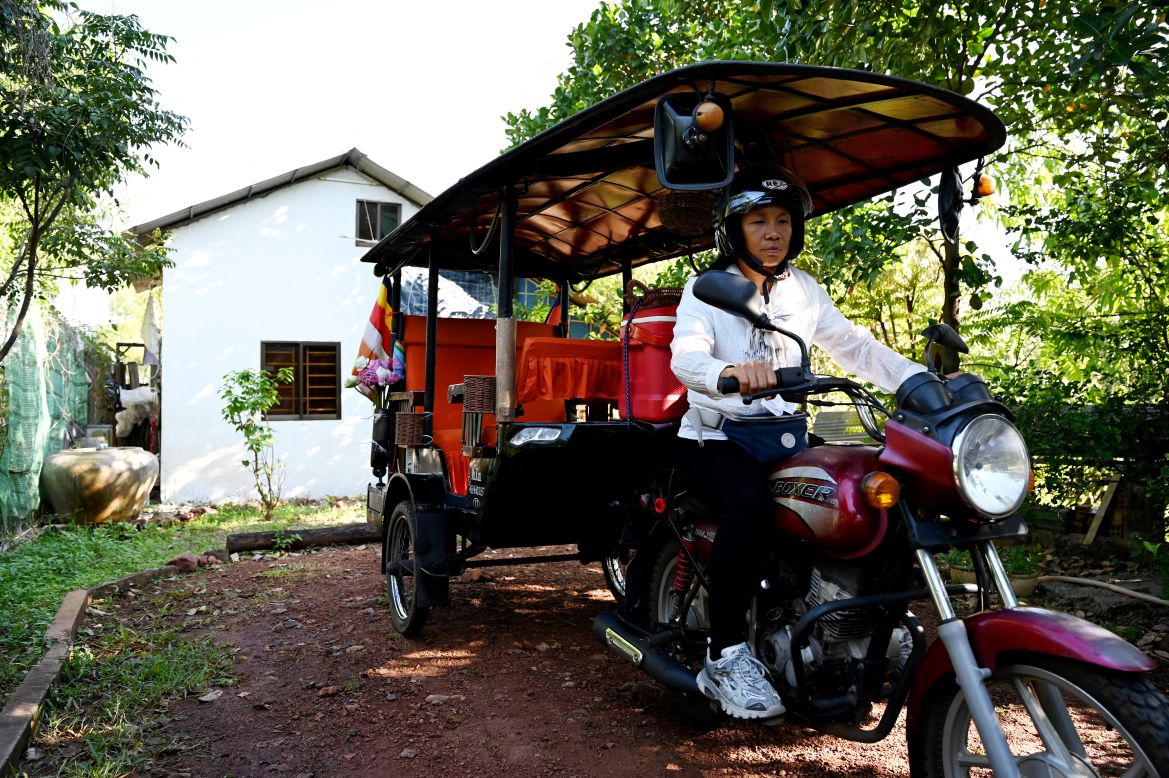 This photo taken on November 18, 2023 shows female Tuk Tuk driver Kim Sokleang leaving her house in Siem Reap province.