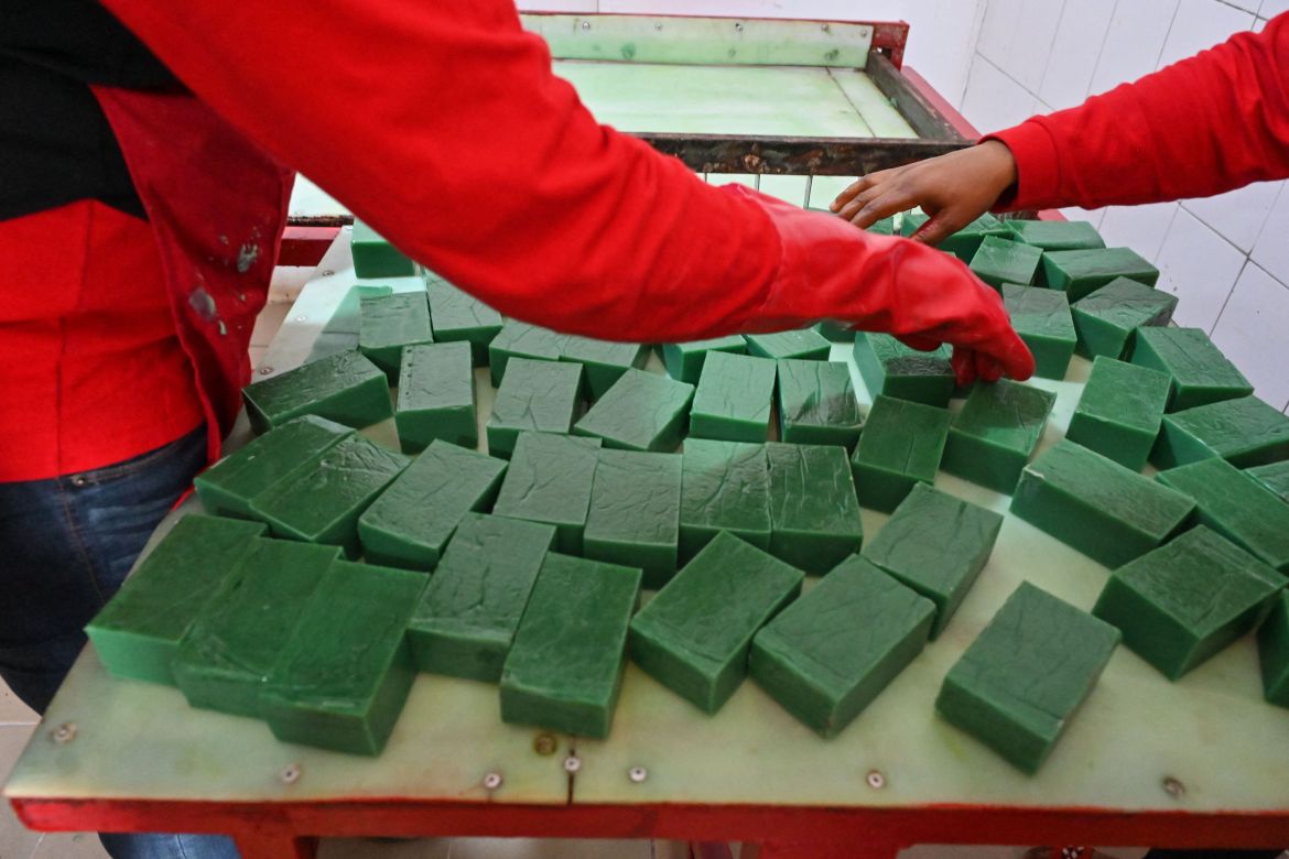 Workers pack soap and gel made from snail slime at the factory in Azaguie.