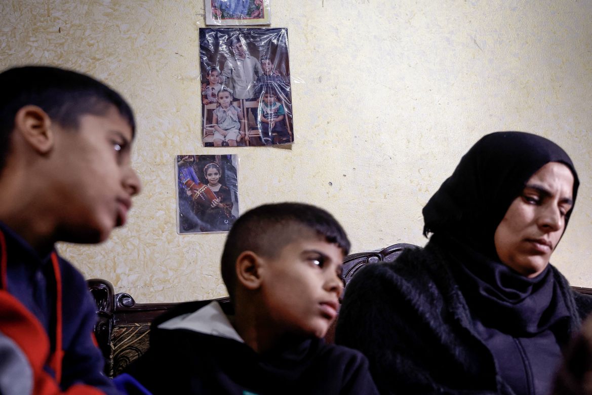 Ikhlas, the widow of Palestinian Bilal Saleh, sits with her children in the village of As-Sawiyah, south of Nablus in the occupied West Bank.