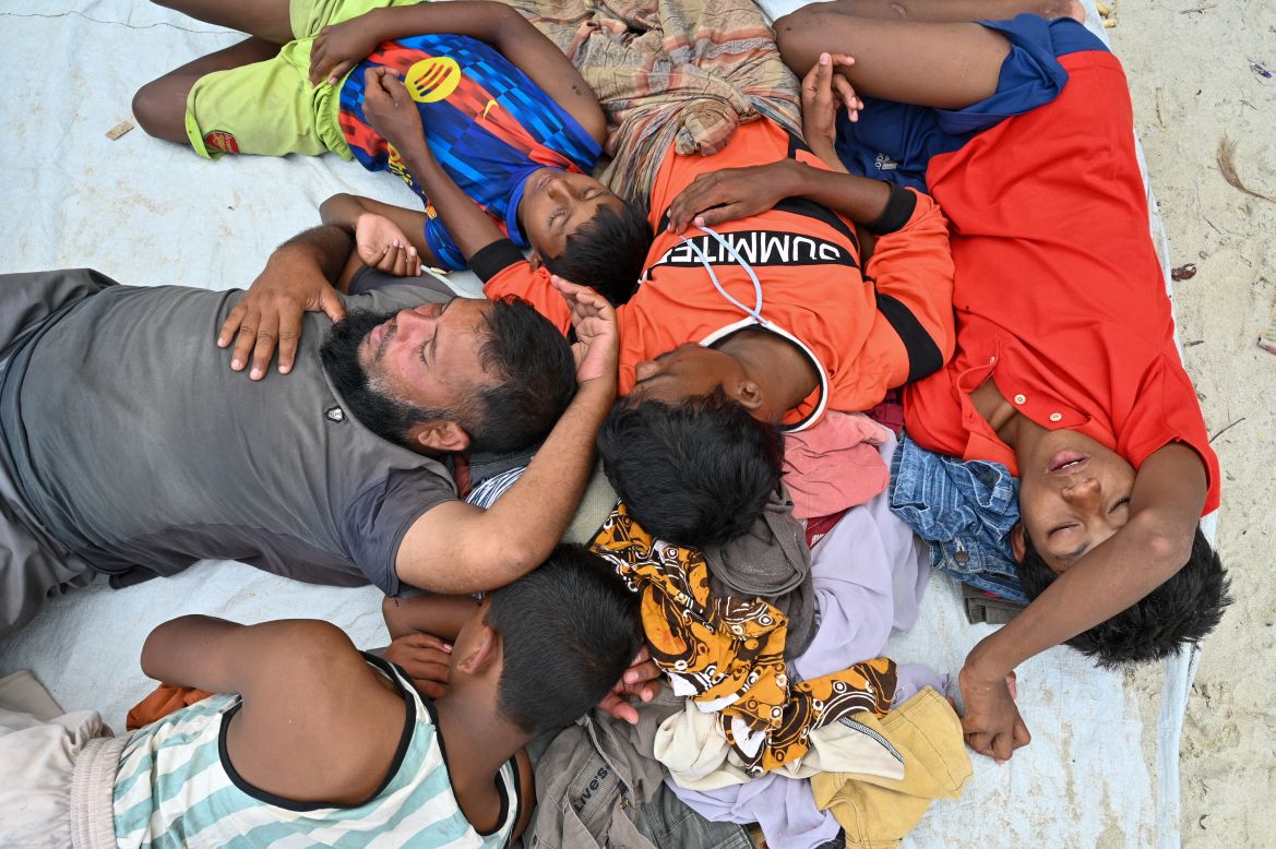 Newly-arrived Rohingya refugees rest at a beach on Sabang island, Aceh province, on December 2