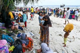 Newly arrived Rohingya refugees rest at a beach on Sabang island in Indonesia&#039;s Aceh province. [Chaideer Mayhuddin/AFP]
