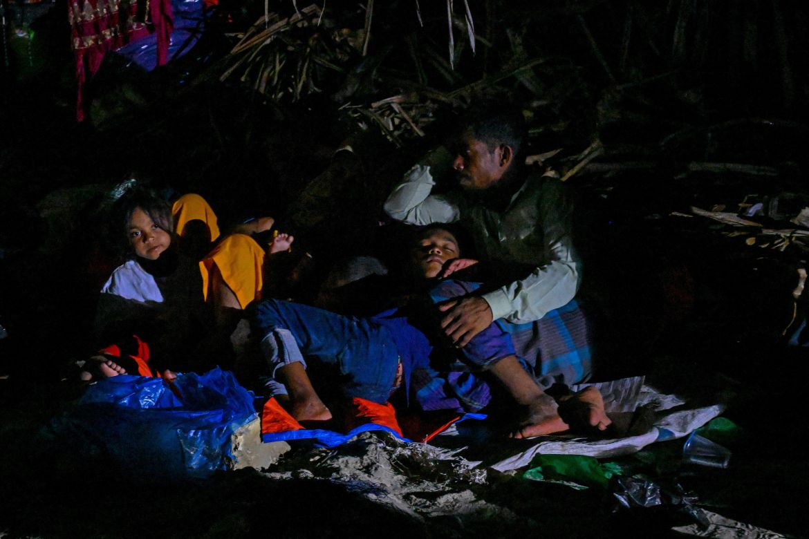 Rohingya refugees rest at a beach on Sabang island, Aceh province on December 2