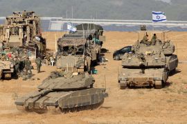 Israeli troops, tanks and military vehicles gather near the border with the Gaza Strip [Jack Guez/AFP]