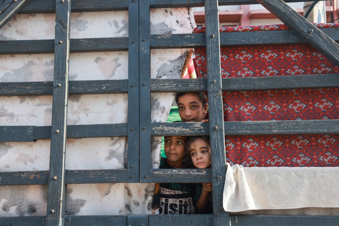 Displaced Palestinian children look out from a makeshift shelter in the courtyard of a government-run school in Rafah in the southern Gaza Strip.