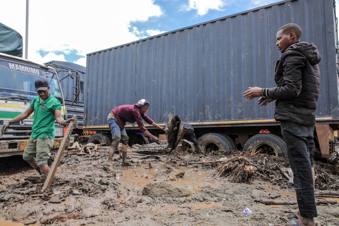 Men assess an area affected by landslides and flooding triggered by heavy rainfall in Katesh, Tanzania .