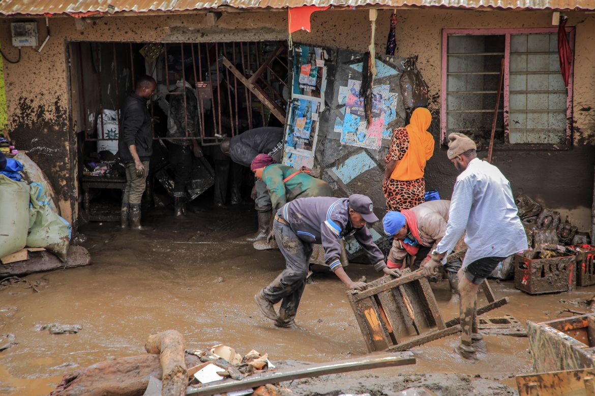 People collect belongings in an area affected by landslides and flooding triggered by heavy rainfall in Katesh, Tanzania.