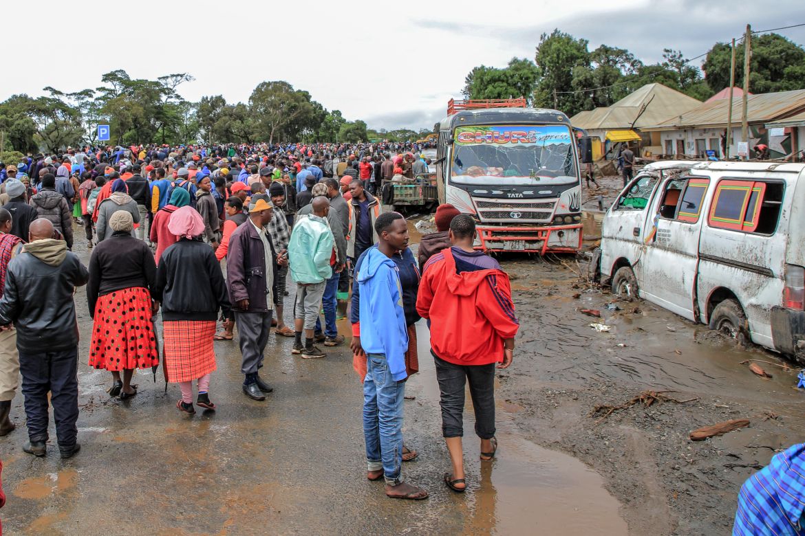 People gather to assess the damages in an area affected by landslides and flooding triggered by heavy rainfall in Katesh, Tanzania.