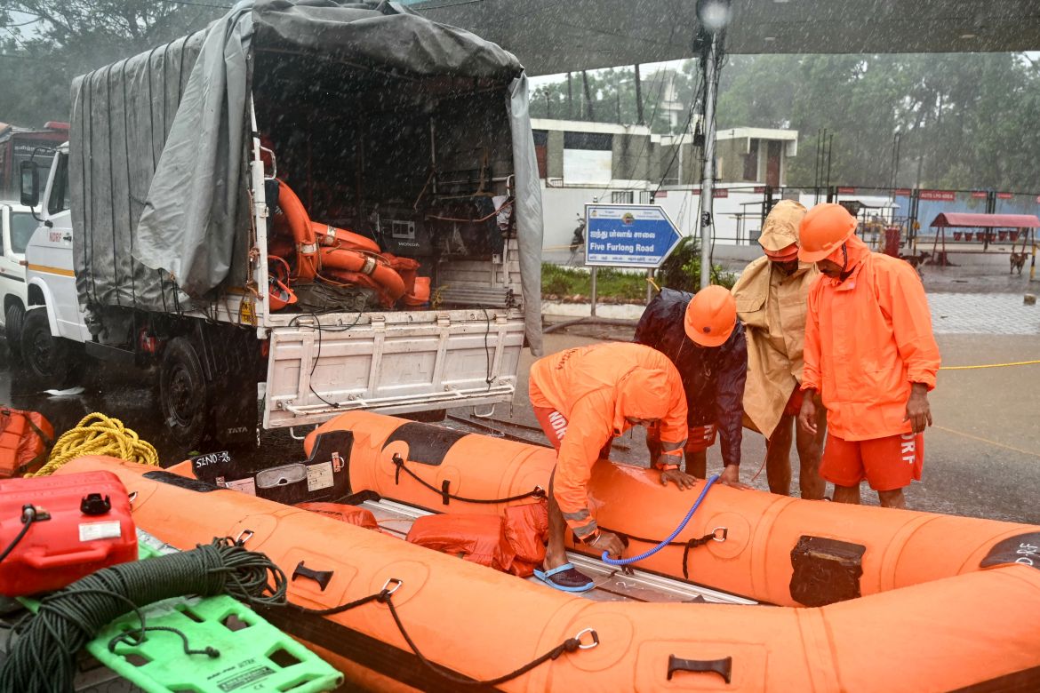 National Disaster Response Force (NDRF) personnel prepare for a rescue operation to help trapped civilians following heavy rainfall in Chennai on December 4