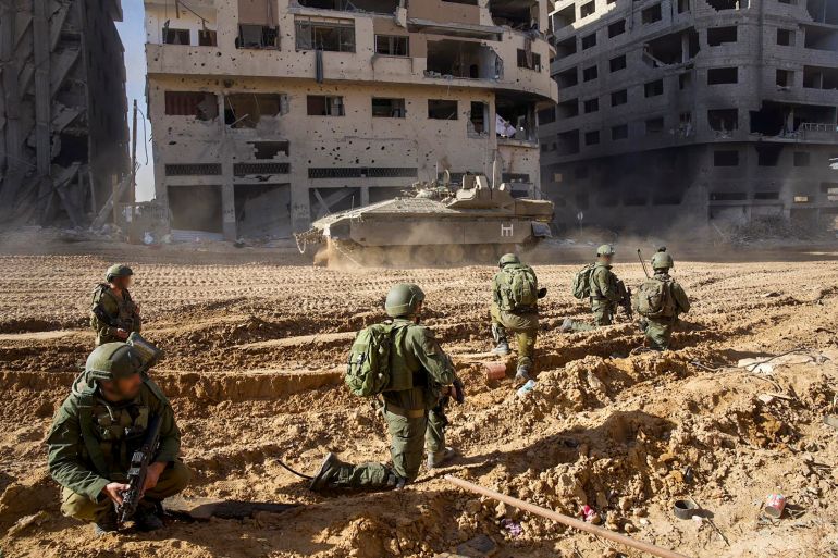 This picture released by the Israeli army shows troops on the ground on the Gaza Strip on December 7, 2023, amid continuing battles between Israel and the Palestinian militant group Hamas. - Israeli troops battled Hamas militants on December 7 in the heart of southern Gaza's main city of Khan Yunis where a suspected mastermind of the October 7 attacks is believed to be hiding, while pressing their offensive across the besieged territory. (Photo by Israeli Army / AFP) / === RESTRICTED TO EDITORIAL USE - MANDATORY CREDIT "AFP PHOTO / HANDOUT / ISRAELI ARMY' - NO MARKETING NO ADVERTISING CAMPAIGNS - DISTRIBUTED AS A SERVICE TO CLIENTS == - === RESTRICTED TO EDITORIAL USE - MANDATORY CREDIT "AFP PHOTO / Handout / Israeli Army' - NO MARKETING NO ADVERTISING CAMPAIGNS - DISTRIBUTED AS A SERVICE TO CLIENTS == /