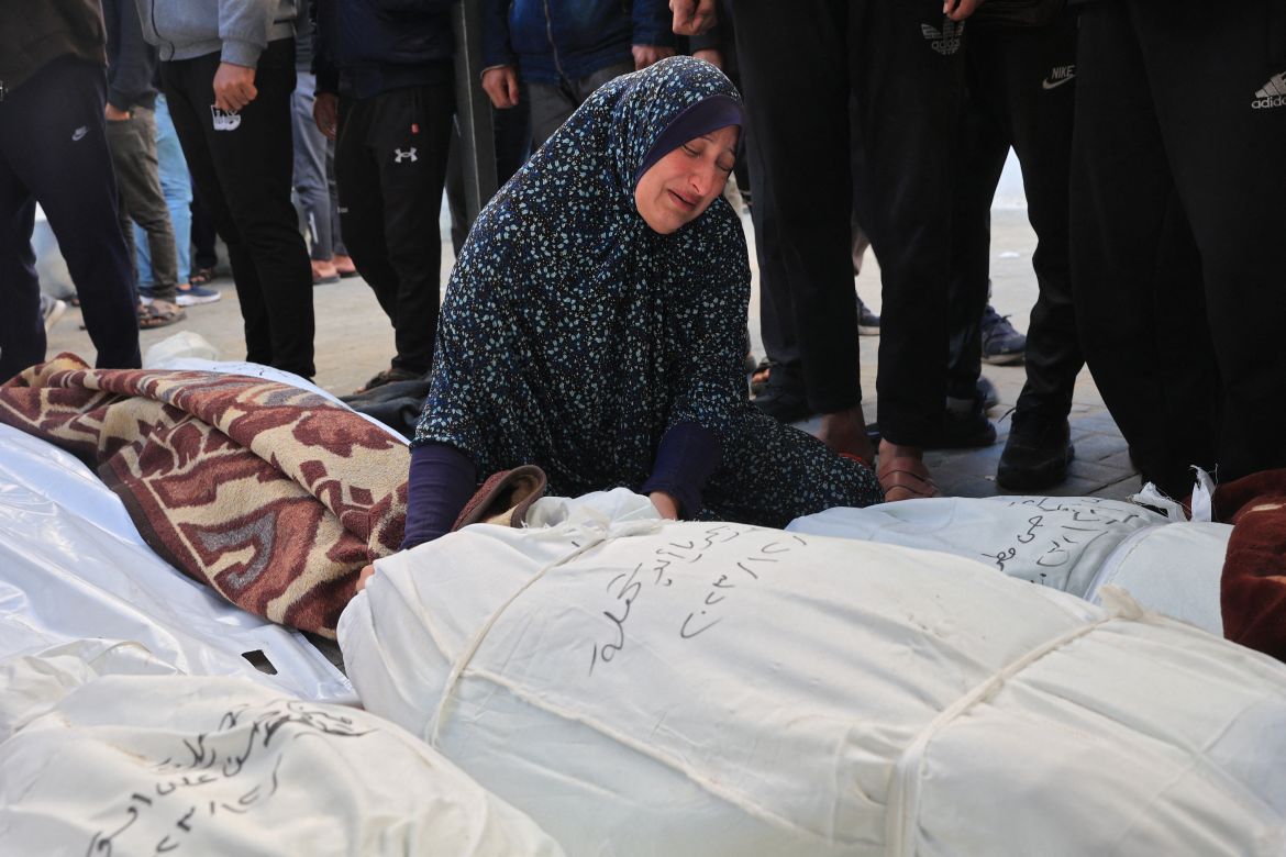 A woman mourns over the bodies of family members killed during Israeli bombardment overnight, at al-Najjar hospital in Rafah on the southern Gaza Strip.