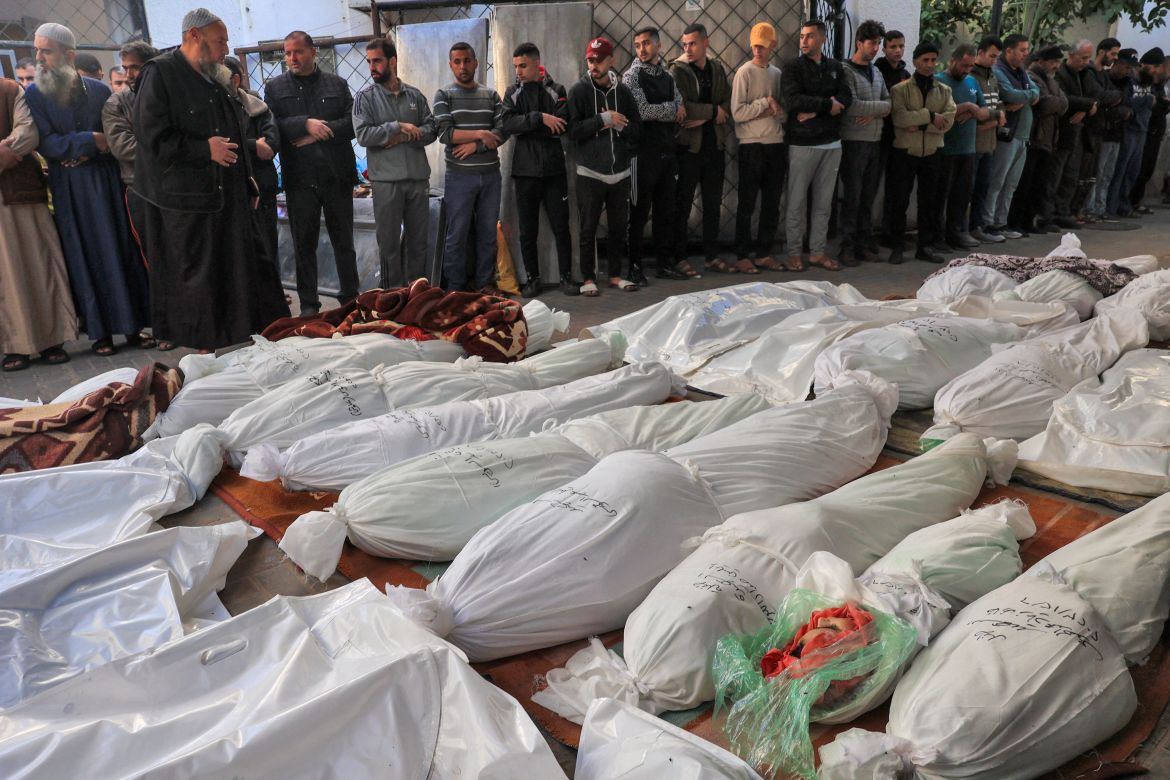 People pray over the bodies of victims killed during Israeli bombardment overnight at al-Najjar hospital in Rafah.