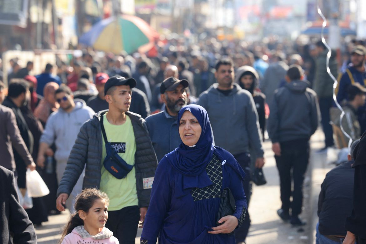 Palestinians crowd a street in Rafah in the southern Gaza Strip on December 9