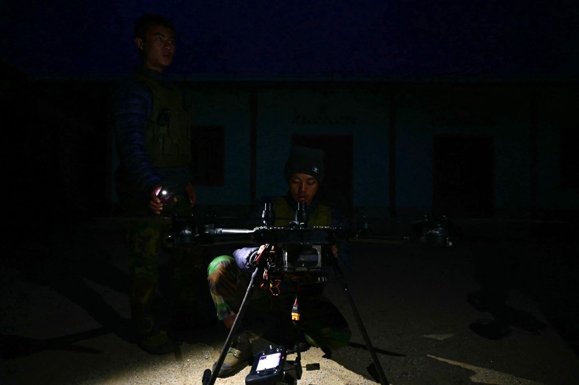 This photo taken on December 12, 2023 shows members of ethnic minority armed group Ta'ang National Liberation Army (TNLA) preparing to launch a drone during their attack on Myanmars military camp in Namhsan Township in Myanmar's northern Shan State.