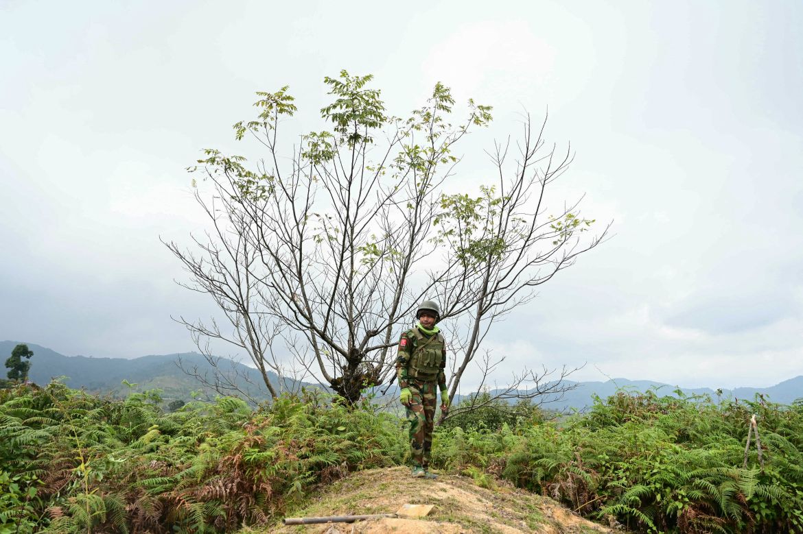 This photo taken on December 13, 2023 shows a member of ethnic minority armed group Ta'ang National Liberation Army (TNLA) standing guard at a hill camp seized from Myanmar's military in Namhsan Township in Myanmar's northern Shan State.