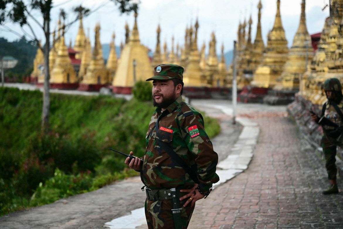 This photo taken on December 12, 2023 shows members of ethnic minority armed group Ta'ang National Liberation Army (TNLA) standing guard in a temple area of a hill camp seized from Myanmar's military in Namhsan Township in Myanmar's northern Shan State.