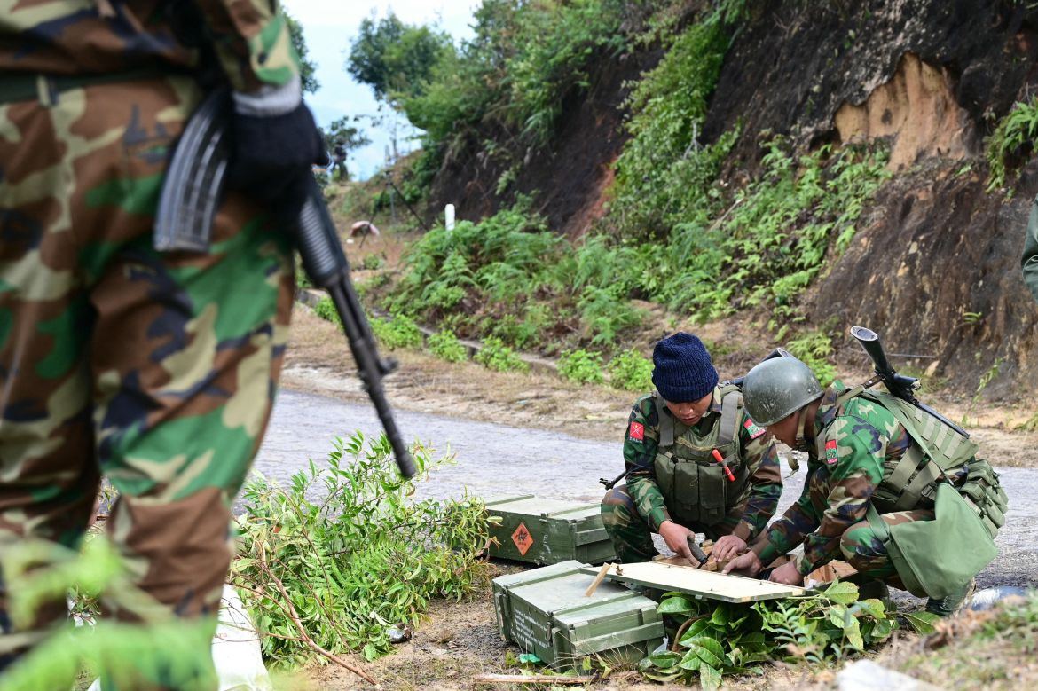 This photo taken on December 13, 2023 shows members of ethnic minority armed group Ta'ang National Liberation Army (TNLA) preparing their weapons amid clashes with Myanmar's military in Namhsan Township in Myanmar's northern Shan State.