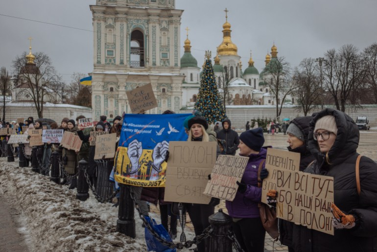Family and friends of Ukrainian POWs call for a rapid prisoner exchange with Russia. They are holding banners and standing in Saint Sophia Square